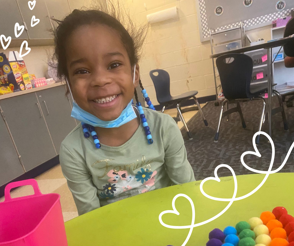 Girl smiling at table